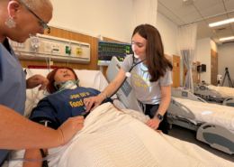 Hanna Johnson works on a patient in the simulation lab alongside Assistant Professor of Nursing, Julie Briere, MSN.