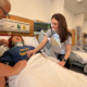 Hanna Johnson works on a patient in the simulation lab alongside Assistant Professor of Nursing, Julie Briere, MSN.