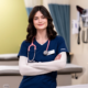 Aubrey Fazzone in a medical clinic smiling with her arms crossed.